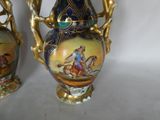 two vases that are decorated with a painting of a man riding a horse