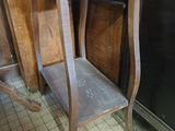 a wooden table with a shelf on it in a room