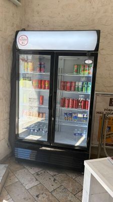 a refrigerated refrigerator in the corner of a building