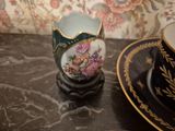 a cup and saucer sitting on a table next to a plate