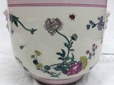 a pink and white bowl with a flower design on it