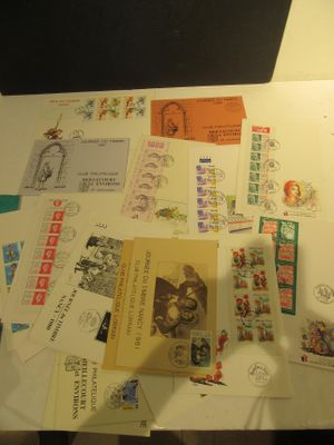 a table with a lot of postcards and stamps on it