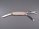 a swiss army knife with a pair of scissors on top of it