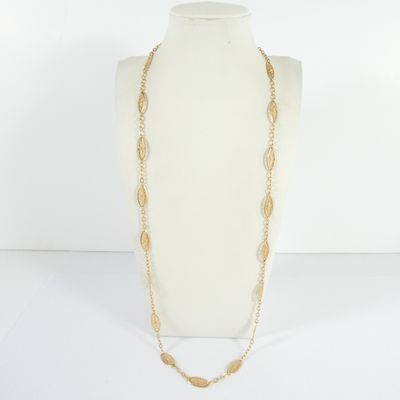 a white mannequin with a gold chain and a long necklace