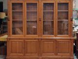 a large wooden cabinet with glass doors in a room