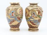 pair of asian vases decorated with images of men and women