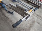 some tools are laying out on a table in a garage