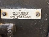 a sign on the back of a machine that says certain items on this equipment have metric threads