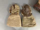 two pairs of mittens that are sitting on a table
