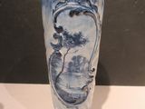 a blue and white vase sitting on a white table