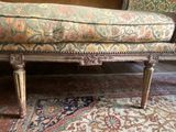 a bench that is sitting on a rug in a room
