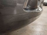 a close up of a car ' s bumper with a hole in it
