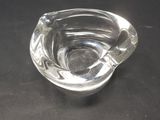 a glass ashtray with a cigarette in it on a table