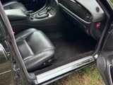 a picture of a black car with its door open