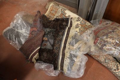 a pile of pillows and other items on the floor
