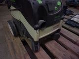 a green and black machine that is sitting on a pallet