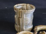 a snake that is standing next to a cup on a table
