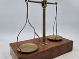 an image of a scale on a wooden stand with a white background