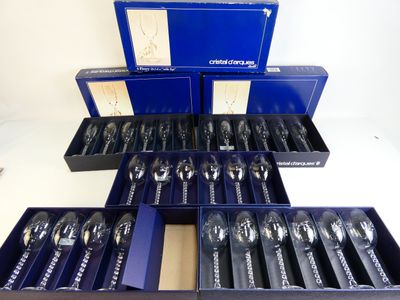 a lot of silverware in a blue box on a table