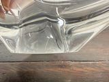 a person holding a glass bowl on a wooden table