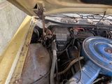 an old car engine with a blue cover on it