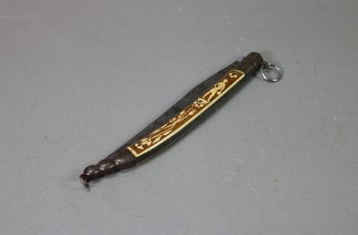 a small knife that is laying on a table