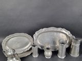 an assortment of silverware including a tray, cups and saucer