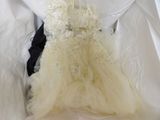 a wedding dress that is in a box on a bed