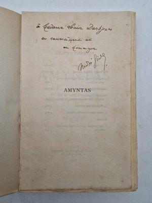 an open book with handwriting on it sitting on top of a table