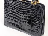 an image of a black crocodile skin handbag on a white background