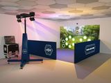 a photo of a room with a large screen and a tv