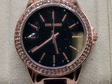 a close up of a watch on display on a display stand