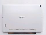the back of a white laptop computer sitting on top of a white table