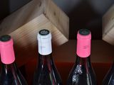 four bottles of wine are lined up in a row on a table