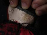 a close up of a person cutting a piece of cloth