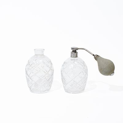 deux bouteilles en verre munies d'une poignée en métal et ornées d'une feuille sur le dessus
