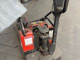 an image of a small machine that is sitting on the ground