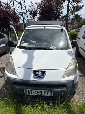 a white van parked in a parking lot next to other cars