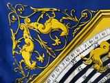 a close up of a blue and yellow pillow with a clock on it
