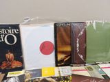 a lot of books and cds on a table