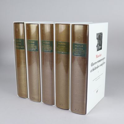four books in a row on a table with a white background