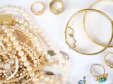 many different types of pearls and rings on the table