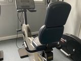 an image of a gym room with stationary exercise equipment