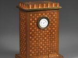 a small wooden clock sitting on top of a table