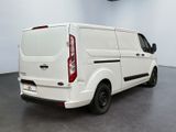 the back of a white van is parked in a large room