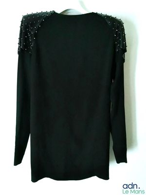the back of a black sweater with silver studding on it