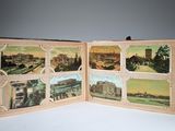an open book with pictures of a city on it