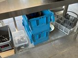 a table with a blue container on it and a blue bin on the floor