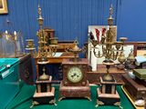 une table sur laquelle se trouvent une horloge et d'autres objets anciens