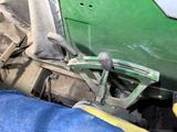 a close up view of the steering wheel of a green tractor